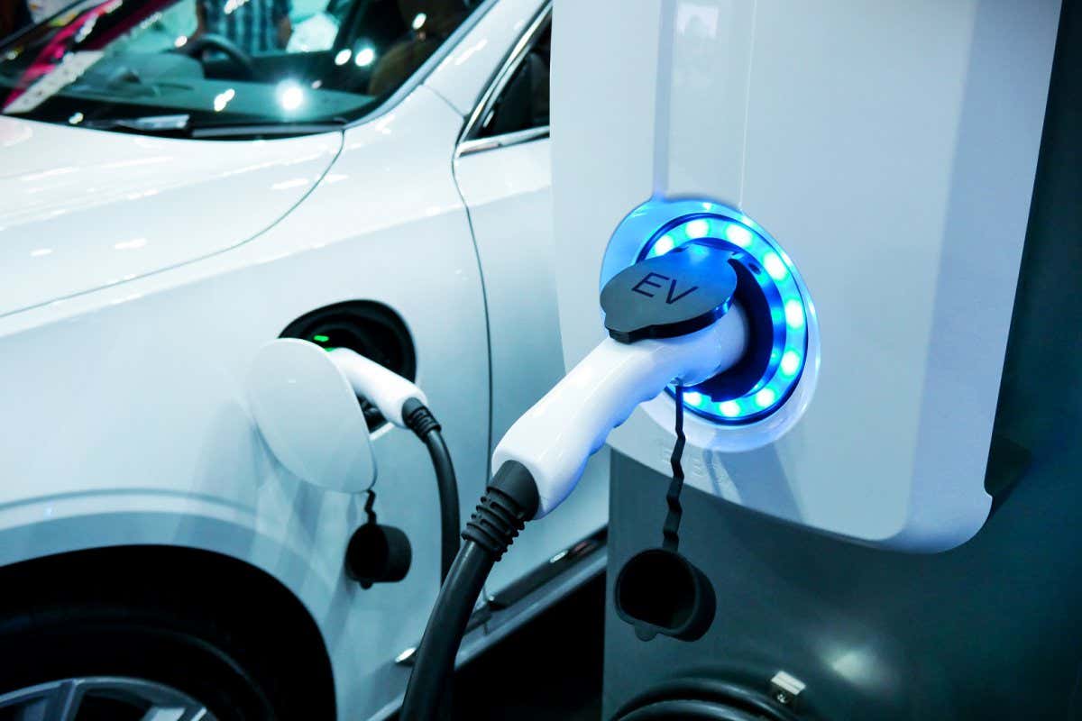 Power supply connect to electric vehicle for charge to the battery. Charging technology industry transport which are the futuristic of the Automobile. EV fuel Plug in hybrid car